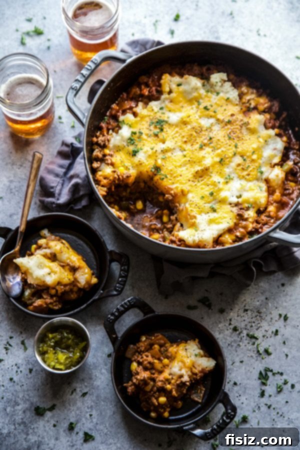 Close-up of baked cheeseburger shepherd's pie in a skillet, garnished with fresh parsley