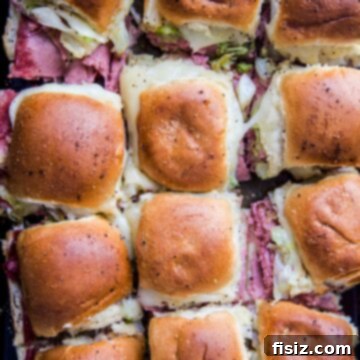 One-Pan Wonder Corned Beef Sliders 8 Sheet Pan Corned Beef Sliders on a baking sheet, golden and delicious.