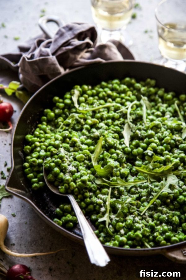 Cacio e Pepe Greens and Peas 6 A vibrant bowl of Peas and Greens with Cacio e Pepe Dressing, garnished with fresh avocado slices, ready to be served. www.climbinggriermountain.com