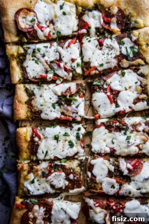 Ultimate Pesto Pepperoni Three Cheese Pizza 3 Another enticing view of the Three Cheese Pesto Pepperoni Pizza, emphasizing its gourmet appearance.