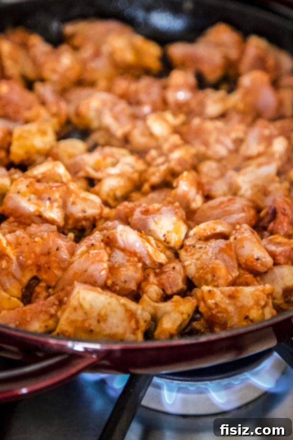 Spicy Thai Chicken Totchos 5 thai chicken cooking in a skillet