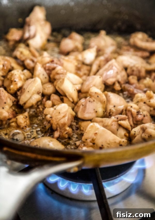 Sweet & Bold Black Pepper Chicken 5 Chicken thighs sizzling and caramelizing in a large skillet with the rich black pepper sauce
