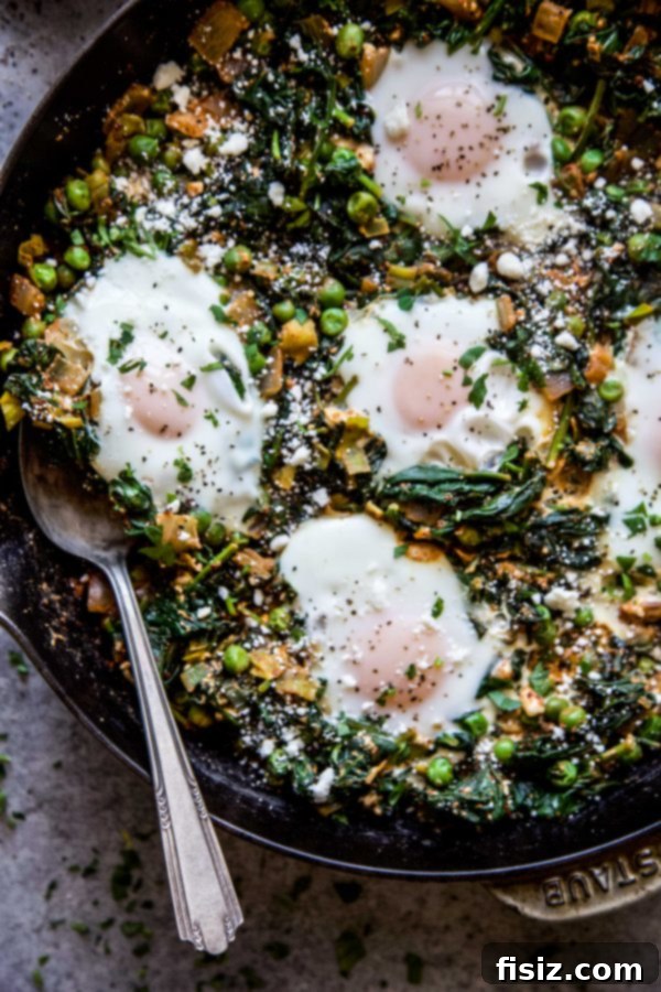 Green Shakshuka with Feta, Spinach, and Peas 3 Close-up of Feta, Spinach, & Pea Shakshuka with poached eggs