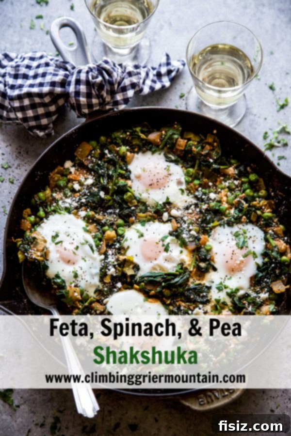 Green Shakshuka with Feta, Spinach, and Peas 9 Close-up of Feta, Spinach, & Pea Shakshuka in a skillet, garnished and ready to eat