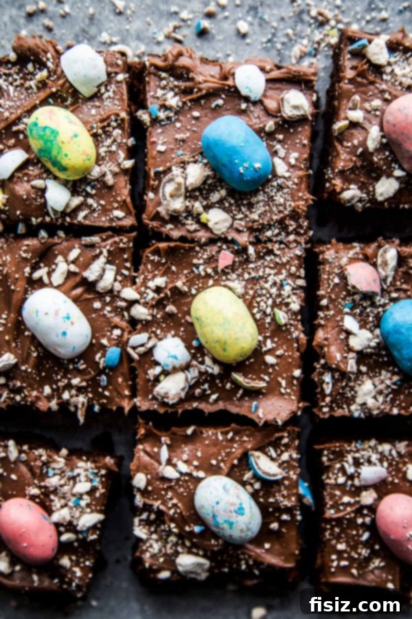 Fudgy Easter Brownies with Decadent Chocolate Cream Cheese Frosting 6 Overhead shot of freshly baked and frosted Chocolate Easter Brownies, garnished with colorful Robin's Eggs, ready to be served.