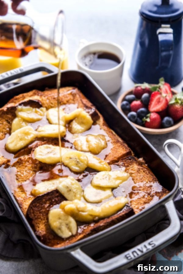 Baked French Toast with Nut Butter and Bananas 7 Close-up shot of a generous slice of Nut Butter-Banana Stuffed French Toast Bake on a white plate
