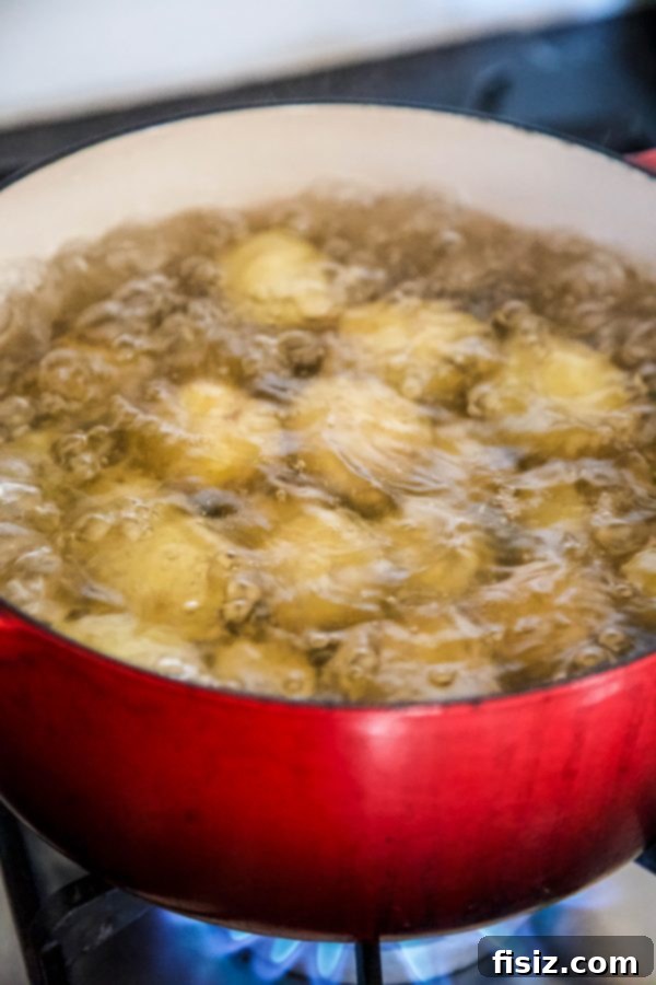 Southern Pimento Cheese Smashed Potatoes 4 Baby potatoes boiling in a pot of water