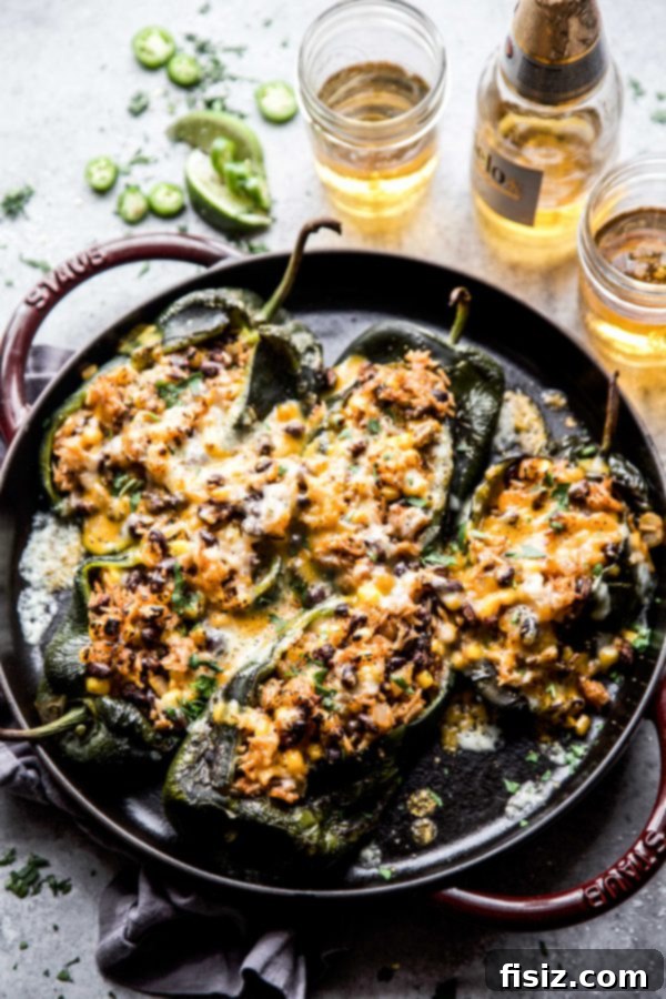 Effortless Chiles Rellenos 3 A top-down shot of several stuffed poblano chiles, garnished with fresh cilantro, ready to be served.