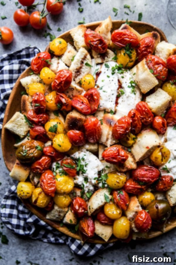 Warm Burrata, Roasted Tomato, and Rustic Bread Medley 7 Overhead shot of Roasted Tomato & Burrata Bread Toss on a rustic serving board