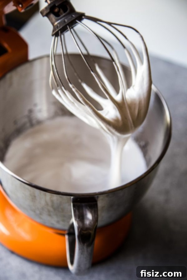 Effortless Smores One Bowl Bake 5 Fluffy marshmallow frosting being mixed in a stand mixer