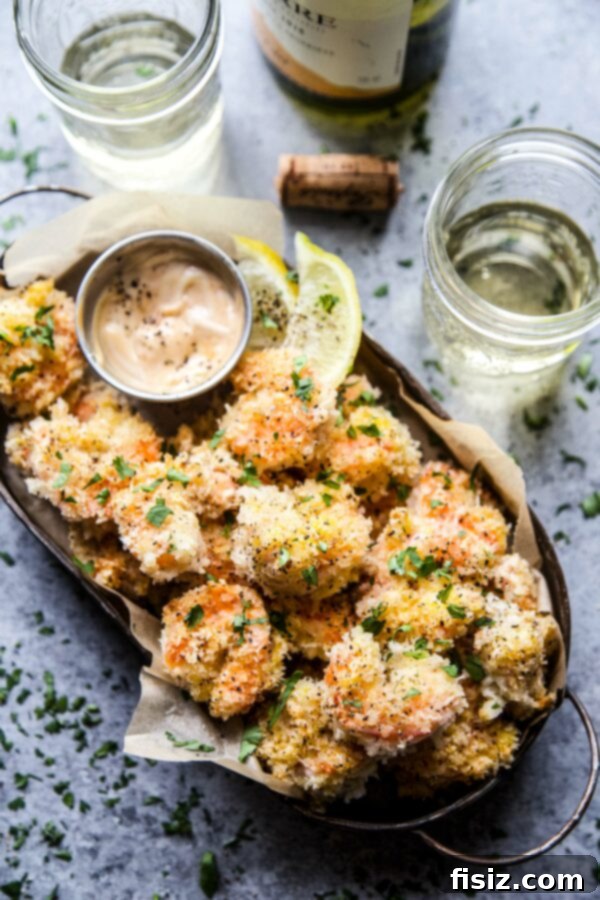 Delicious Hot Honey Coconut Baked Shrimp on a serving dish, garnished with fresh herbs, ready to eat.