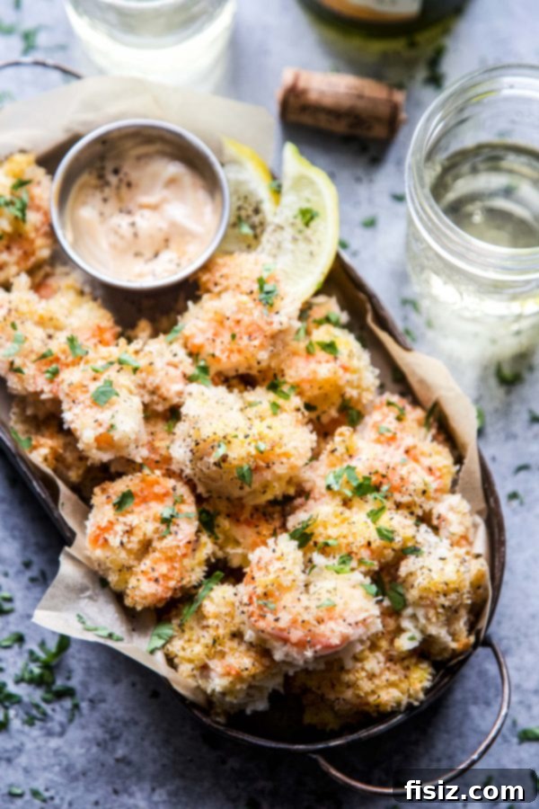 Platter of perfectly cooked Hot Honey Coconut Baked Shrimp, vibrant pink and golden, ready for serving.