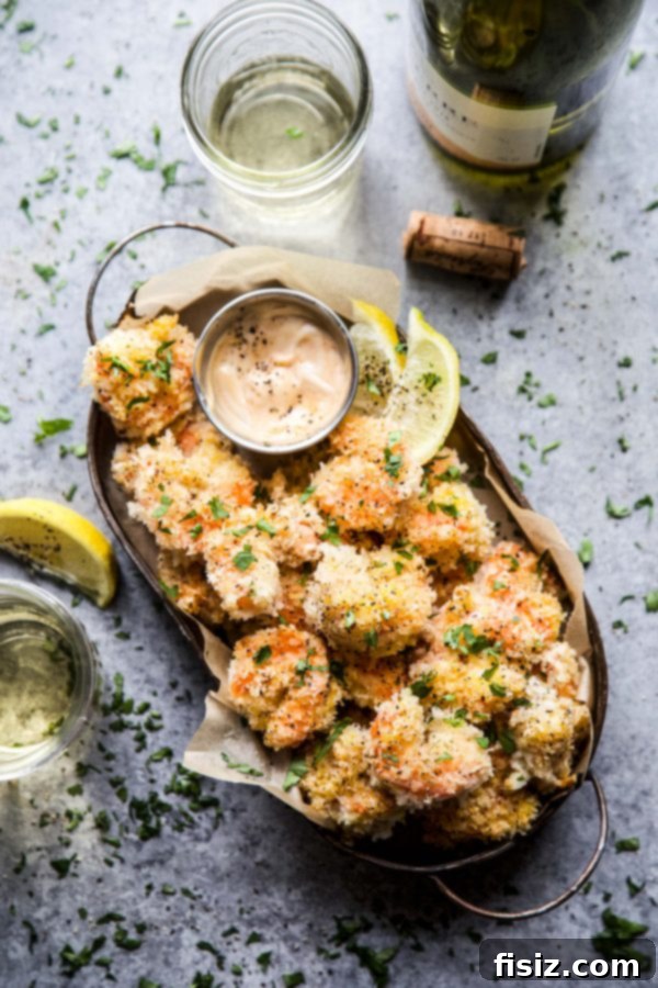 Close-up of a serving bowl filled with Hot Honey Coconut Baked Shrimp, garnished with fresh cilantro.