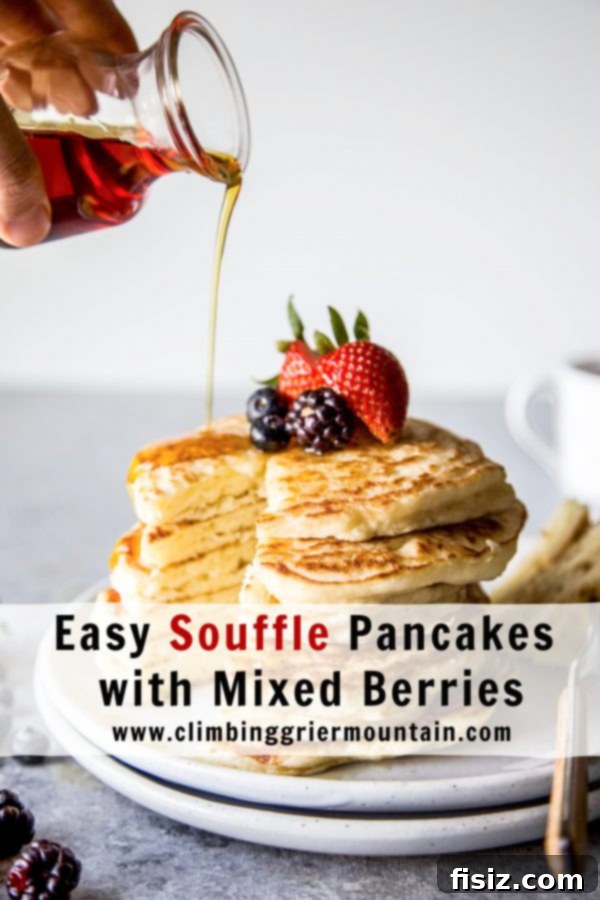 Cloud-Like Soufflé Pancakes with Fresh Berries 9 A final close-up of a stack of fresh Soufflé Pancakes, garnished with vibrant mixed berries and dripping with maple syrup