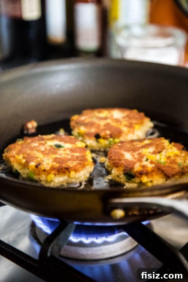 Jalapeno Popper Inspired Crab Cakes 5 Jalapeno Popper Crab Cakes cooking in a hot skillet with olive oil