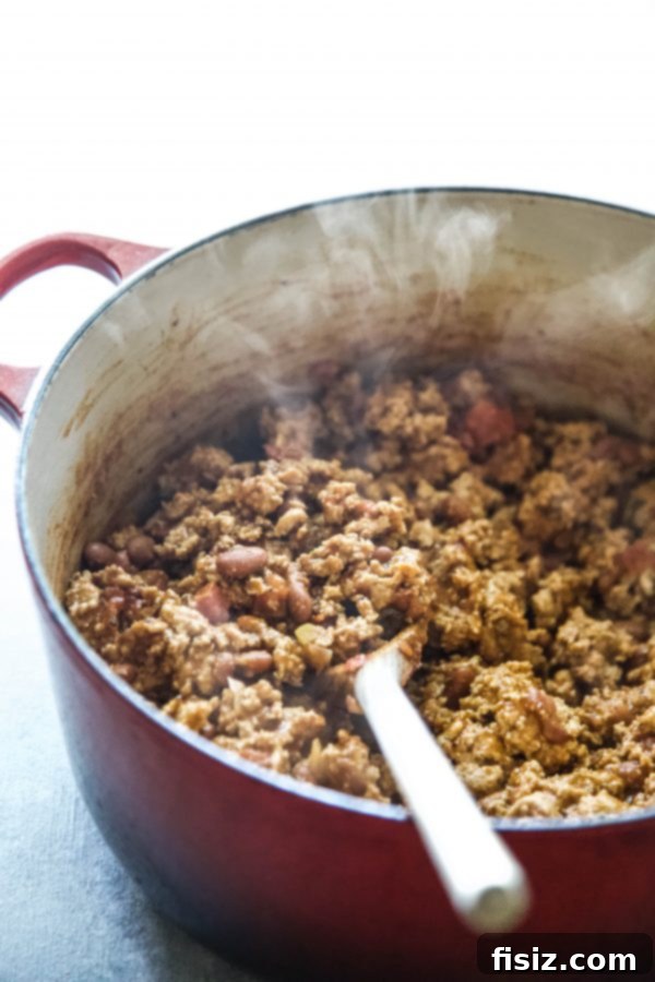 Western Turkey Burrito Bake 4 Ground turkey cooking in a hot skillet with olive oil, ready for seasoning