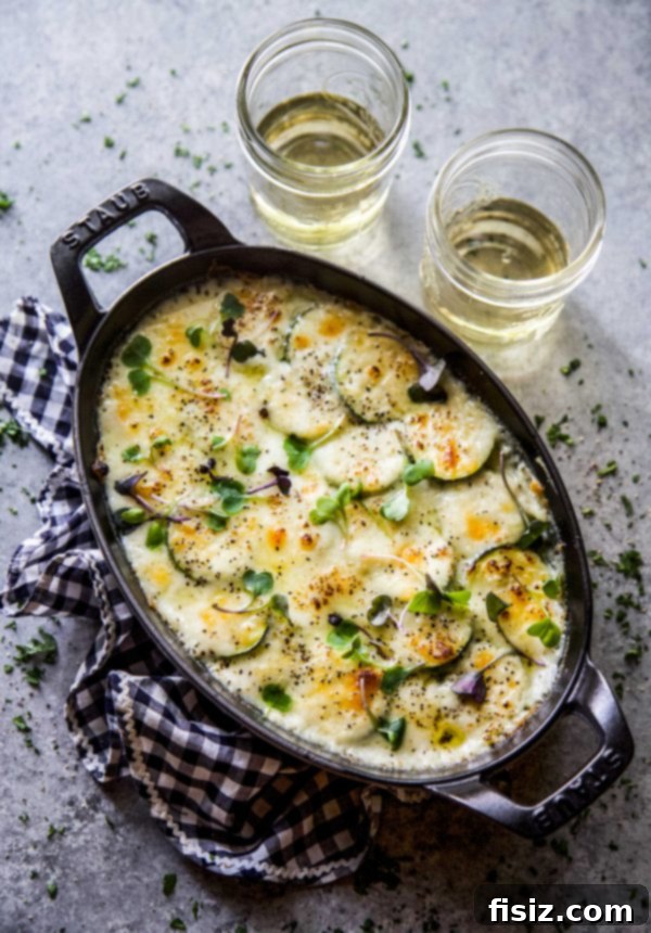 Guilt-Free Cheesy Zucchini Gratin 2 Cheesy Scalloped Zucchini in a skillet, showcasing the golden-brown crust.