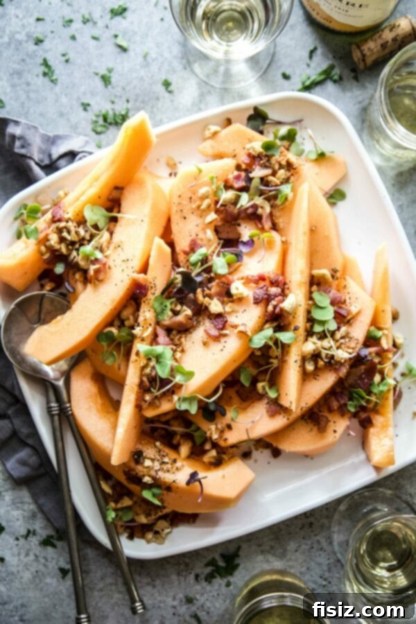 Savory Melon Crunch 2 Juicy cantaloupe slices topped with a crispy bacon-cashew crumble, garnished with fresh microgreens, ready to be served.