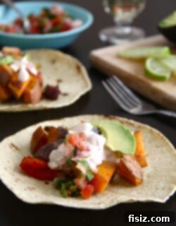 Smoky Sweet Potato Tacos with Creamy Chipotle 2 A perfectly plated sweet potato taco with chipotle cream, garnished and ready to eat.