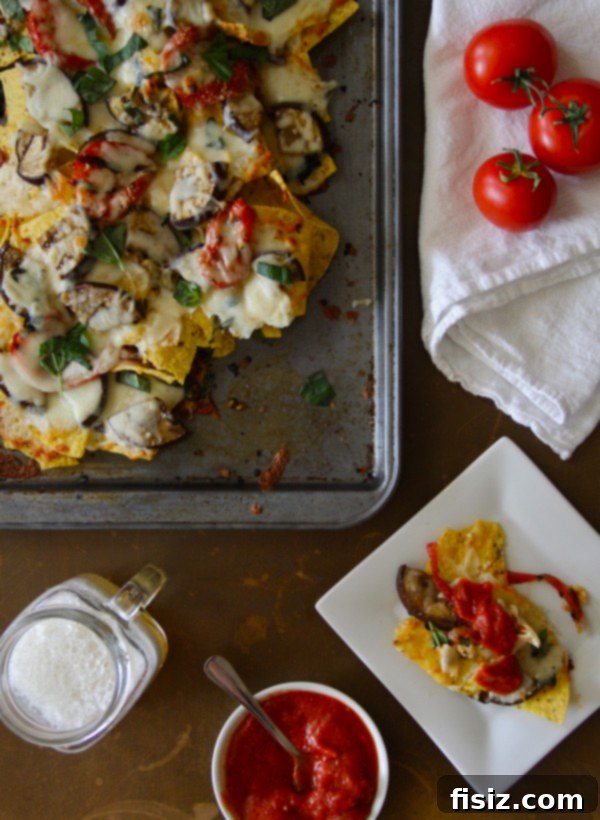 Smoky Eggplant Parmesan Nachos 5 Close-up of finished grilled eggplant parmesan nachos with marinara dipping sauce