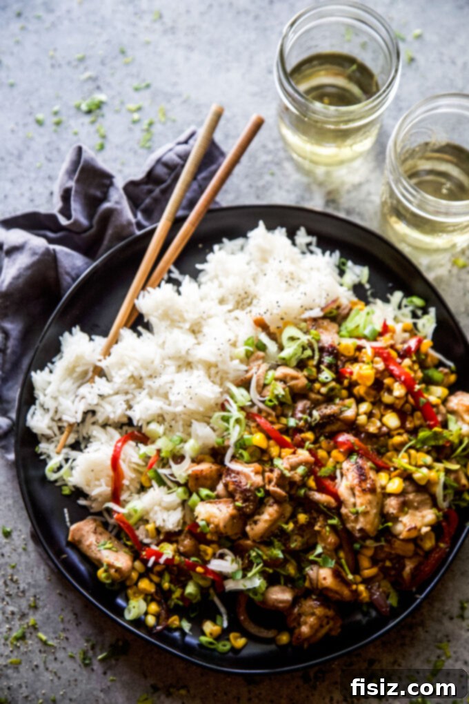 Speedy and Savory Chicken Corn Stir-Fry 6 Easy Chicken & Corn Stir-Fry elegantly served in a bowl with rice and fresh herbs, ready to be enjoyed