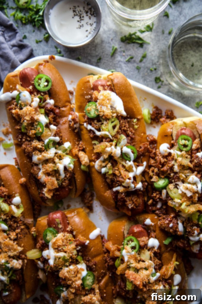 Close-up of a Loaded Chorizo & Kimchi Hot Dog, showing the rich toppings and crisp texture