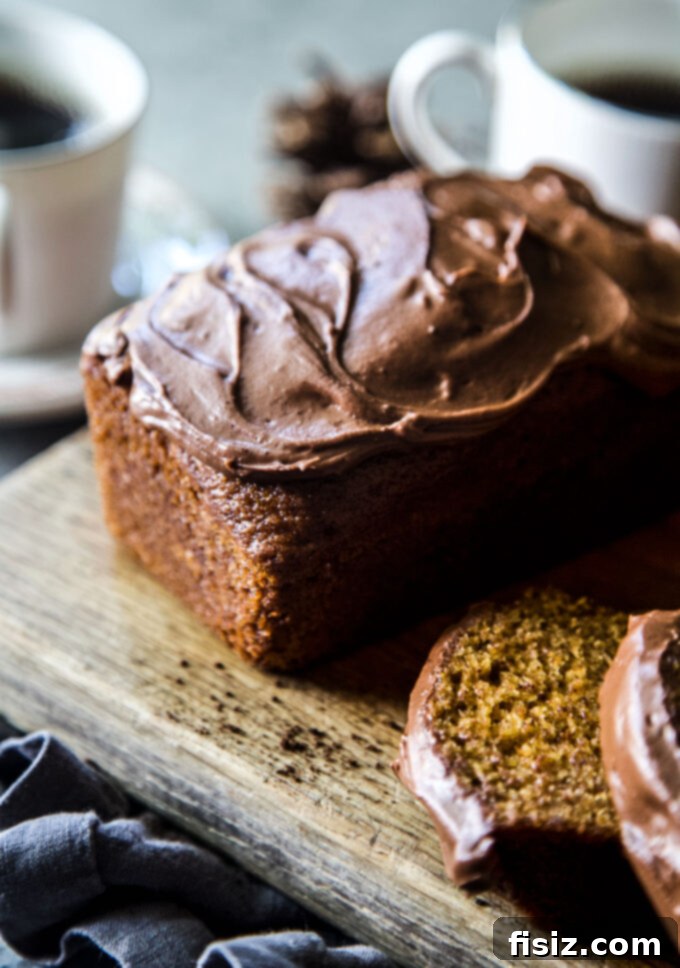 Decadent Chocolate Pumpkin Loaf 3 A slice of moist Chocolate Frosted Pumpkin Bread with rich espresso frosting, ready to be enjoyed.