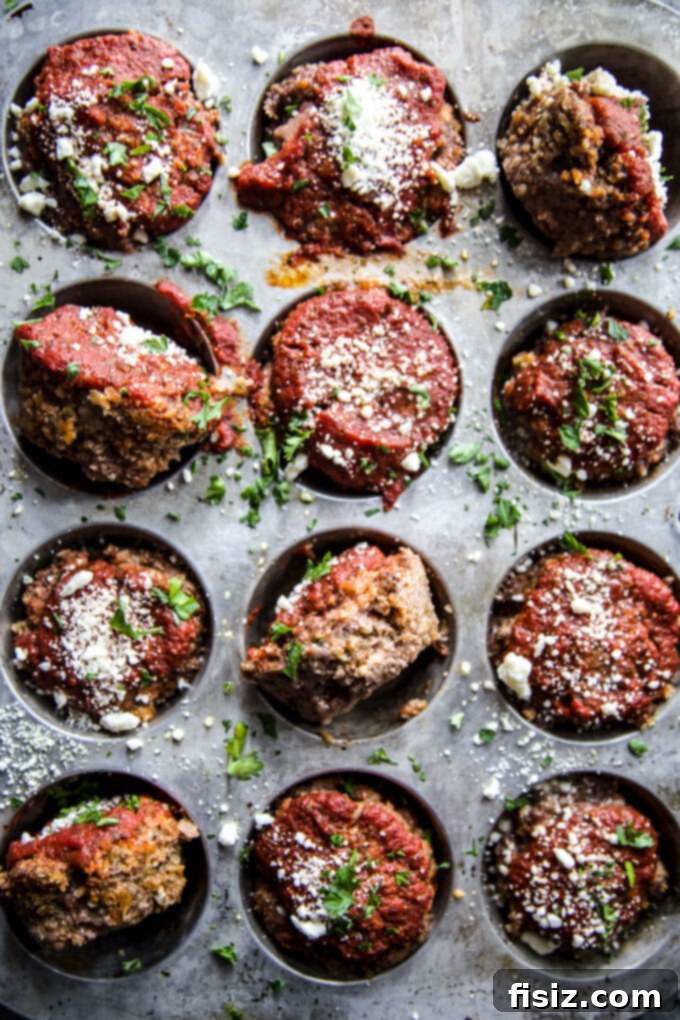 Spiced Beef & Feta Meatloaf Muffins 7 A spread of Spiced Beef Meatloaf Muffins with Feta, showcasing their inviting golden-brown tops and rich sauce.