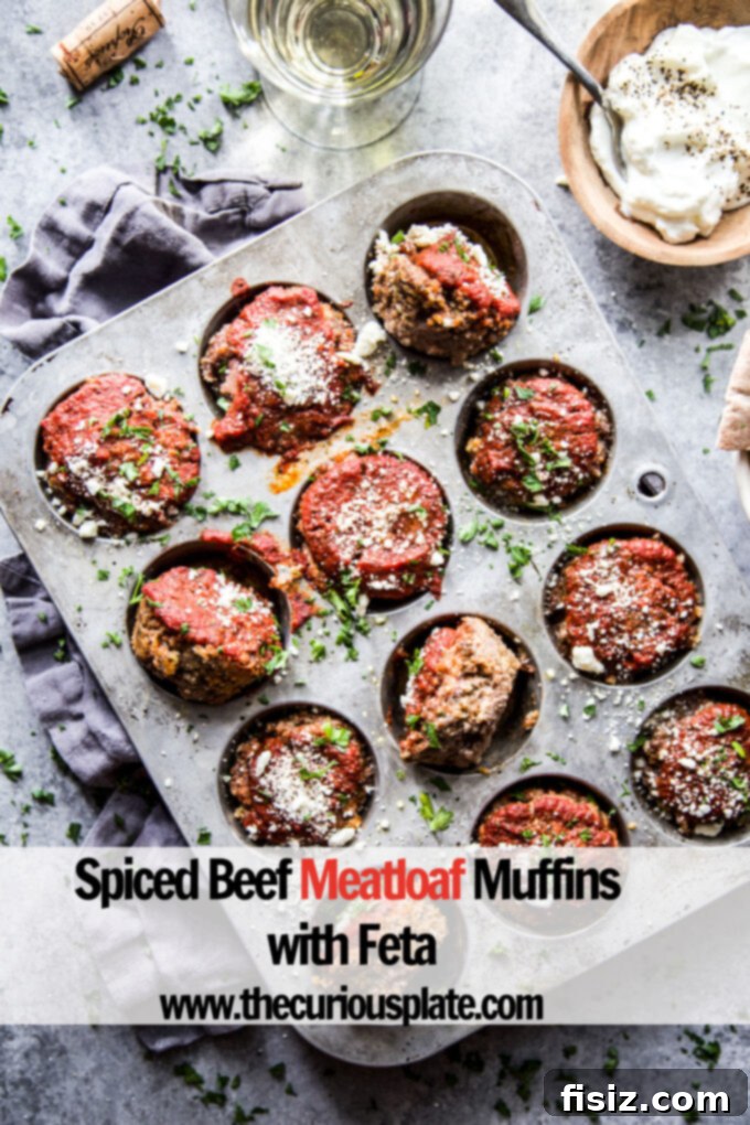 Spiced Beef & Feta Meatloaf Muffins 9 Spiced Beef Meatloaf Muffins with Feta garnished with fresh parsley and ready for a meal.