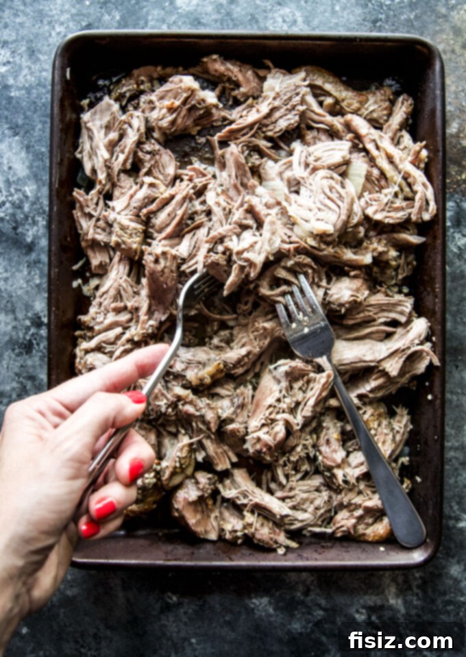 Succulent Slow Cooker Lamb Sliders & Tangy Pepper Relish 6 shredded lamb shoulder on a baking sheet