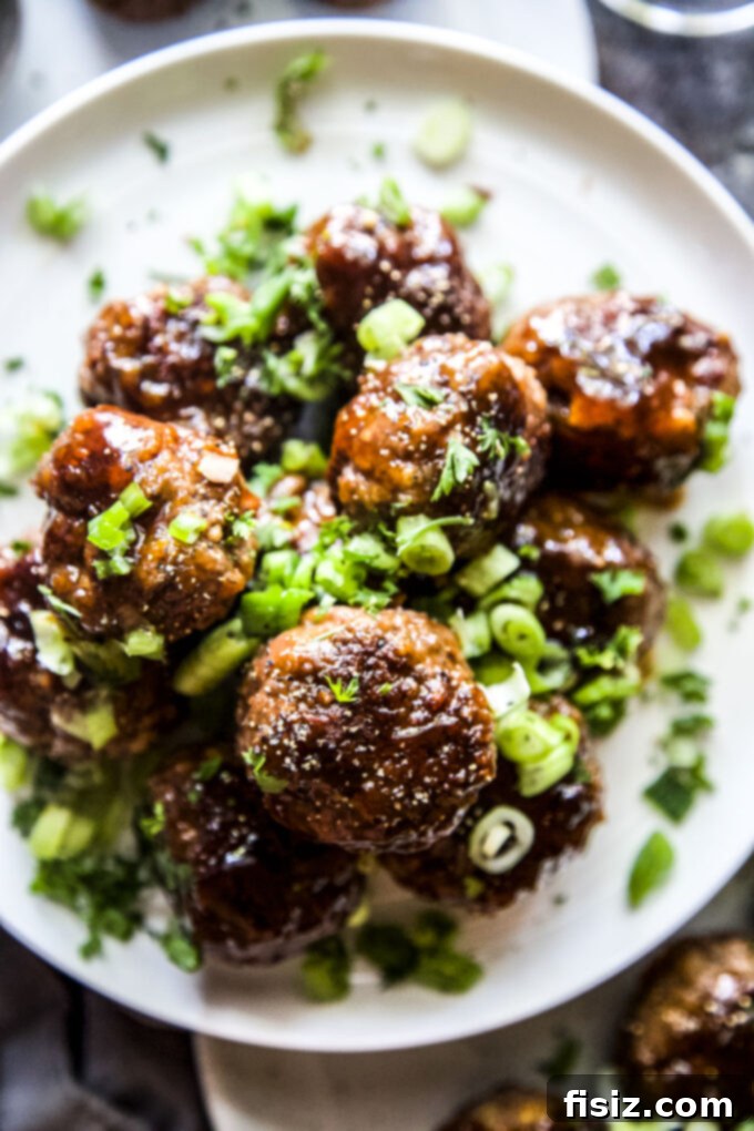 Caramelized Apple Beef Meatballs 3 Platter of freshly cooked Apple Glazed Beef Meatballs, ready to be served, highlighting their glossy, rich glaze and garnishes.