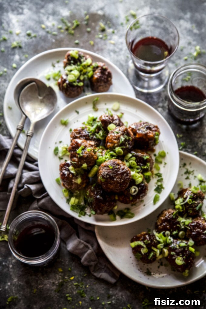 Caramelized Apple Beef Meatballs 7 Overhead shot of a full plate of Apple Glazed Beef Meatballs garnished with green onions, suggesting a delicious meal.
