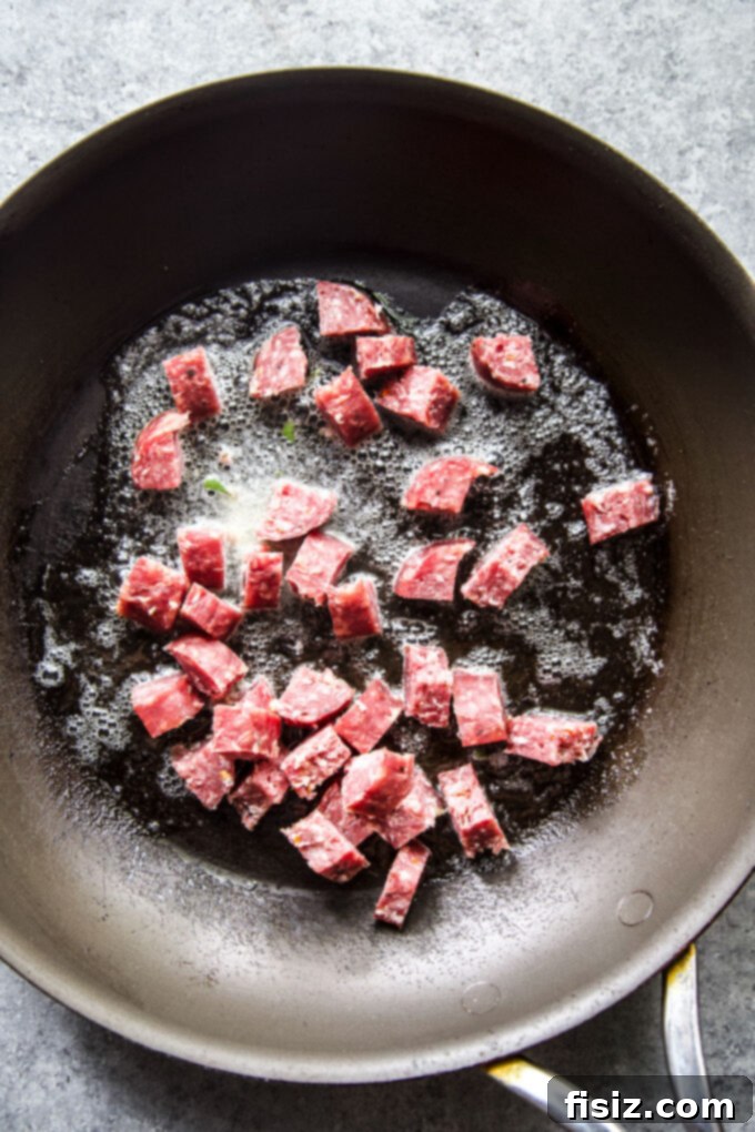 Savory Salami Cornbread Stuffing 4 Salami sizzling in a skillet, preparing for cornbread stuffing