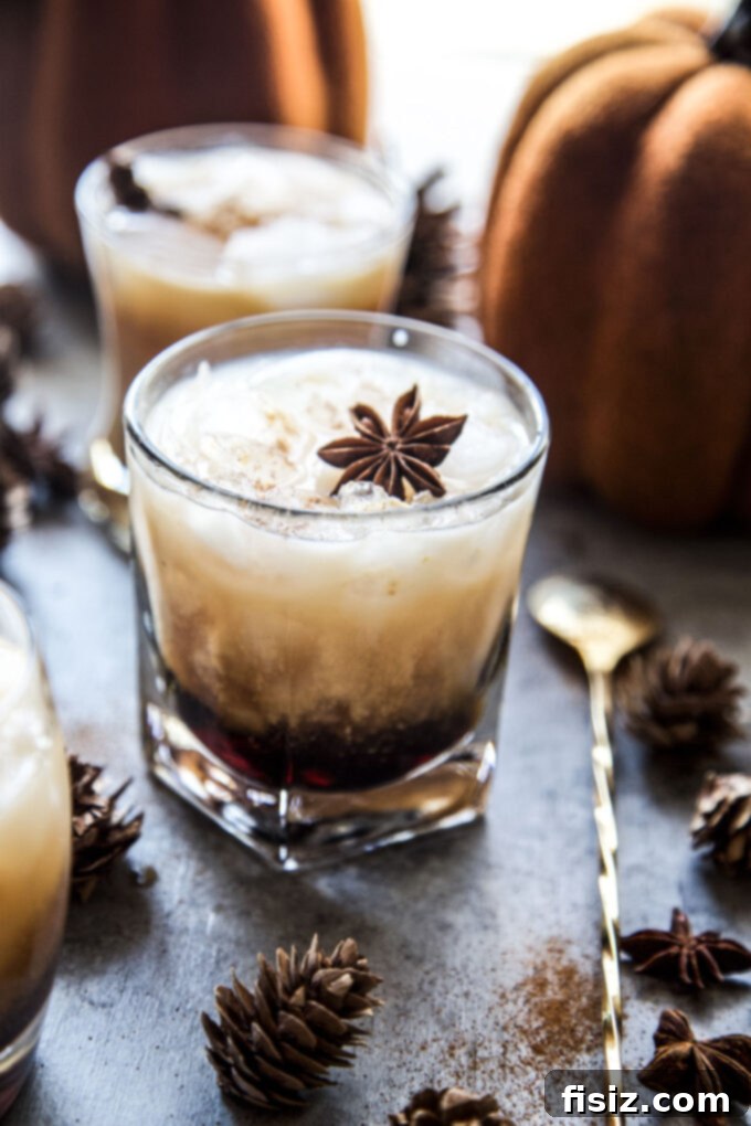 Velvet Pumpkin Russian 3 Two Pumpkin White Russian cocktails in glasses, garnished with cinnamon sticks.