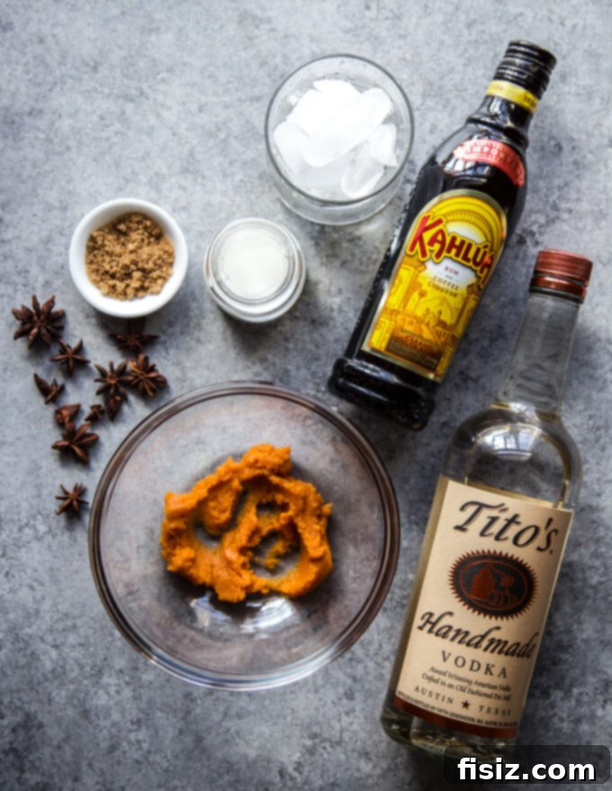 Velvet Pumpkin Russian 4 Ingredients for Pumpkin White Russian Cocktail laid out on a table.