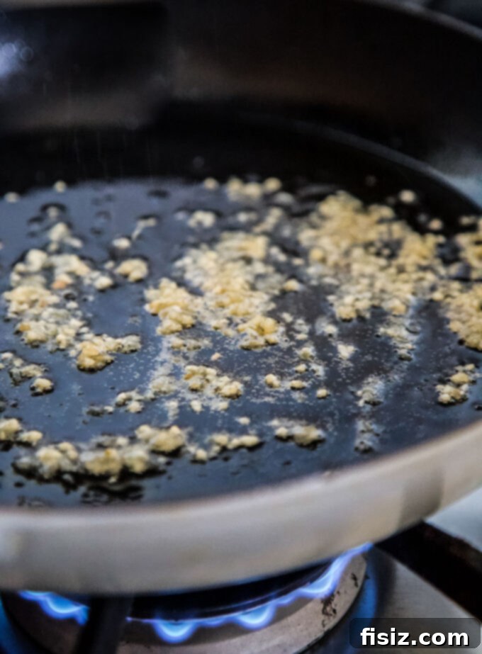 Easy One-Pan Egg Roll Skillet 5 Ginger and garlic cooking in a hot skillet
