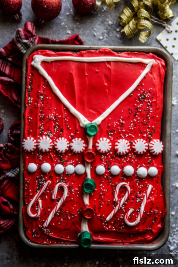 Ugly Sweater Chocolate Cake Extravaganza 3 Close-up of the Ultimate Ugly Sweater Chocolate Cake, showing intricate candy decorations on a red frosted cake.