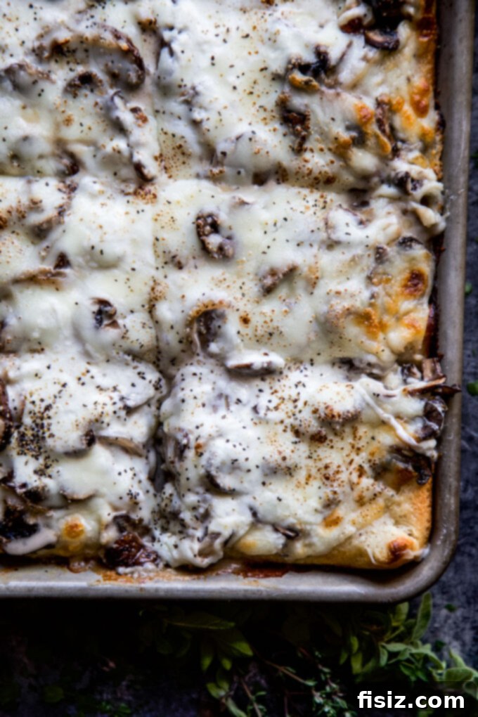 Creamy Burrata Mushroom Sheet Pan Pizza 3 Close-up of Sheet Pan Mushroom & Burrata Pizza, showcasing the creamy burrata and golden crust.