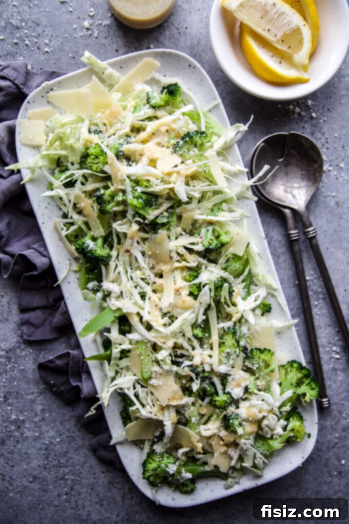 Crisp Broccoli Caesar 2 A beautifully presented Broccoli Caesar Salad with fresh green broccoli florets, shredded cabbage, and creamy dressing on a white plate, ready to be enjoyed.