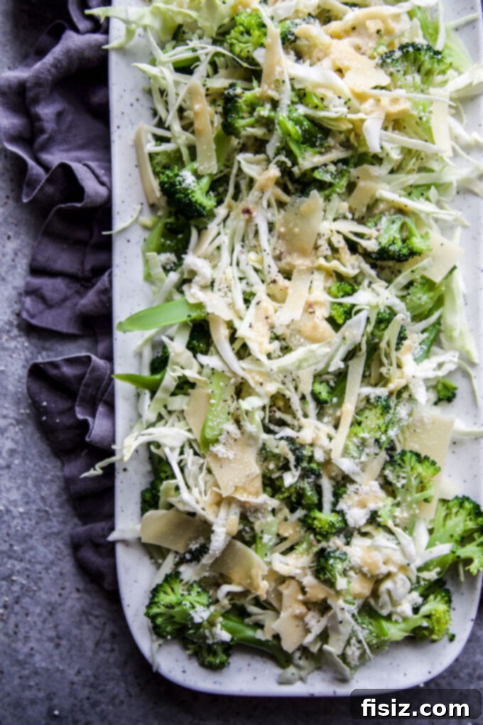 Crisp Broccoli Caesar 3 Close-up of fresh broccoli florets and shredded Napa cabbage tossed with Caesar dressing, highlighting the vibrant green and crisp textures.