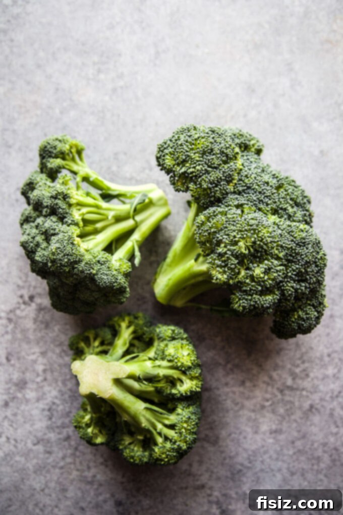 Crisp Broccoli Caesar 5 A large bowl filled with blanched broccoli florets and finely shredded Napa cabbage, ready to be tossed with the homemade Caesar dressing.