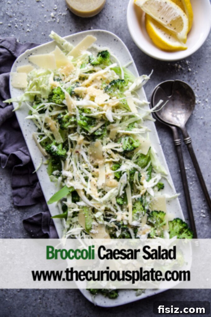 Crisp Broccoli Caesar 7 An overhead shot of a large serving bowl filled with Broccoli Caesar Salad, garnished generously with grated Parmesan cheese, invitingly ready to be served.