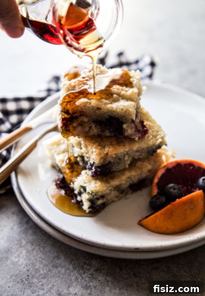 Delicious Blueberry & Blood Orange Sheet Pan Pancakes, golden brown and topped with fresh fruit, perfect for an easy breakfast or brunch.