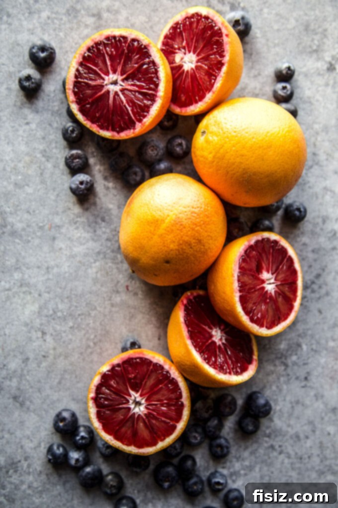 A selection of fresh blueberries and vibrant blood oranges, ready to be incorporated into the sheet pan pancake batter.