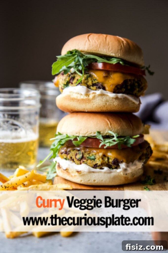 Aromatic Curry Plant-Based Burger 12 Two curry veggie burgers on a plate with French fries and a drink