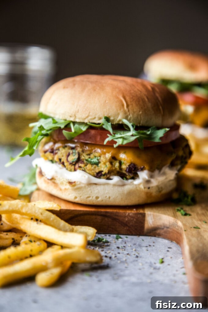 Aromatic Curry Plant-Based Burger 10 Curry veggie burgers with melted cheddar cheese in an oven-safe skillet