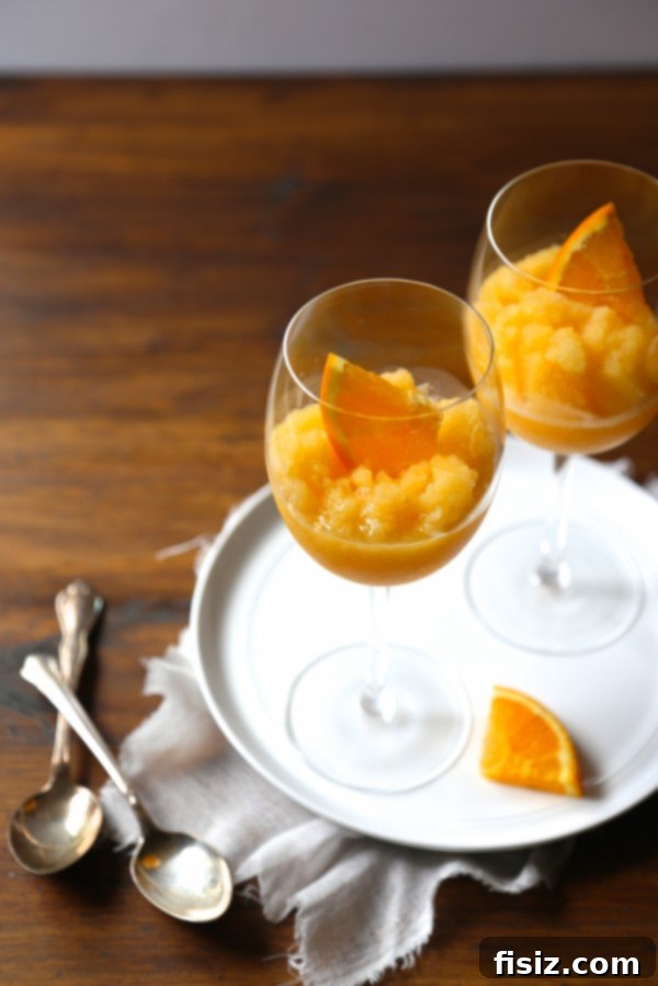 Can't Wait to Make These in February! 6 Refreshing Orange-Peach Mimosa Slushies in elegant glasses, garnished with fruit