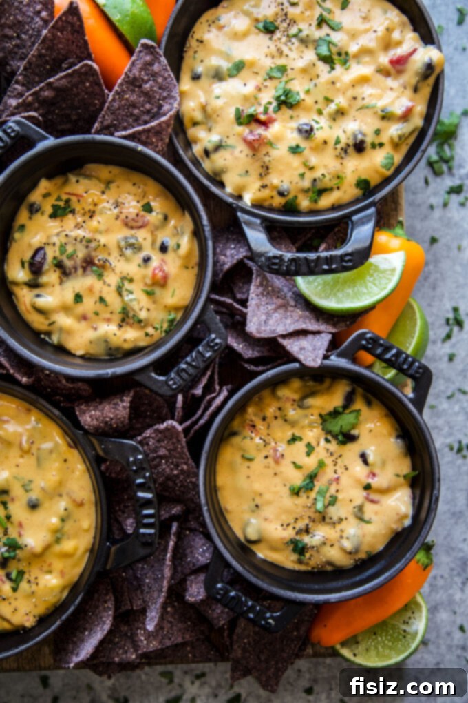 Creamy Slow Cooker Tex-Mex Queso 3 Close-up of a bubbling slow cooker full of Tex-Mex queso