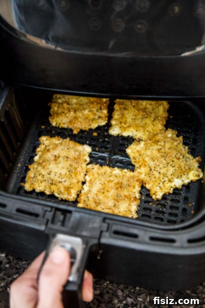 Air Fryer Four Cheese Ravioli Made Easy 7 Air fryer basket filled with breaded ravioli before cooking
