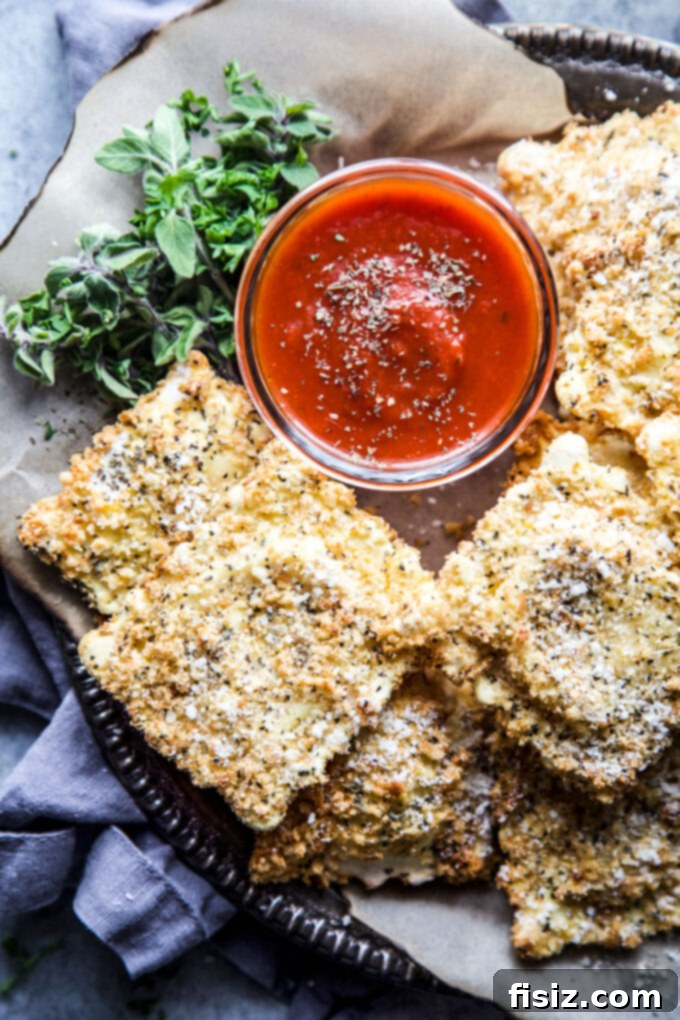 Air Fryer Four Cheese Ravioli Made Easy 9 A serving of Easy Air Fryer Four Cheese Ravioli on a plate with fresh basil